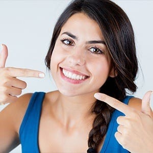 Woman pointing to healthy teeth and gum