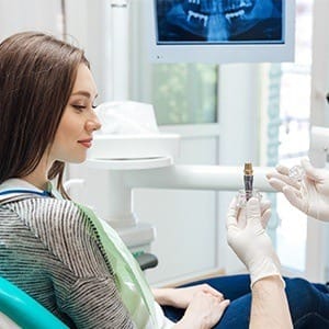 Dentist showing patient a smile model