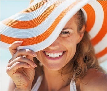 Laughing woman wearing sun hat