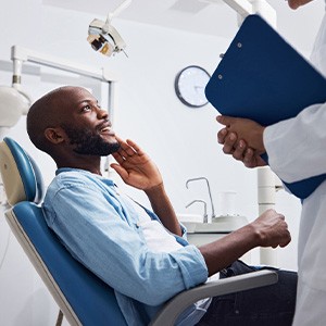 Dentist discussing dental crowns with a male patient
