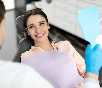 Happy patient smiling at her dentist