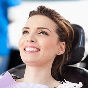 Woman in dental chair smiling