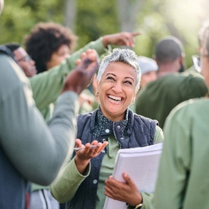 Closeup of senior woman with dentures smiling outside