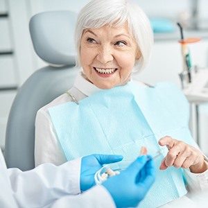 Woman smiling with dentures in North Naples