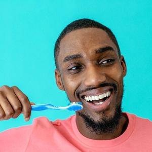 Man brushing teeth in North Naples