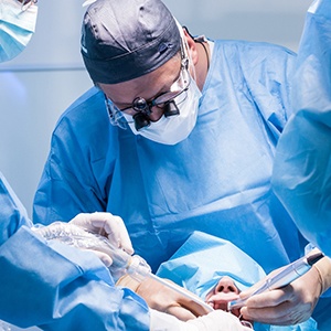 dentist holding up model of dental implant