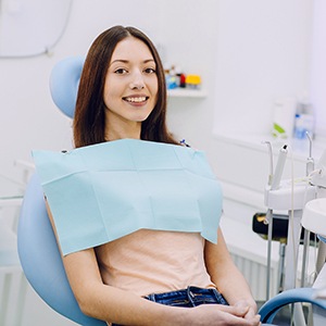 Female dental patient smiling in dental chair