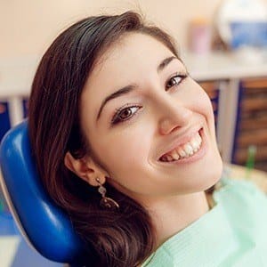 Woman in dental chair smiling