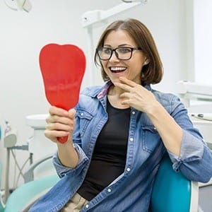 Woman looking at smile in mirror