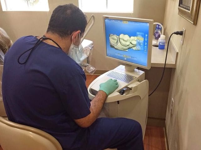 Dentist looking at digital bite impressions