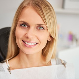 Blonde female dental patient smiling after full mouth reconstruction in North Naples, FL
