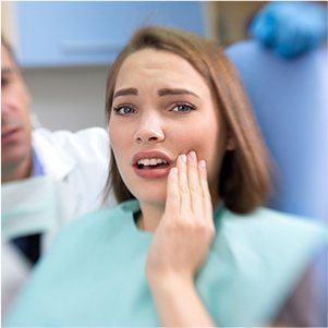 Woman in pain holding cheek