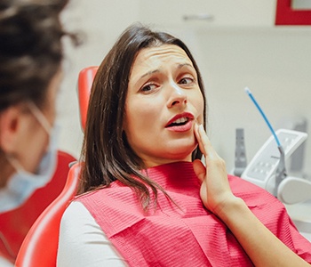 Woman with tooth pain at the dentist