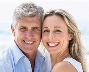 Smiling older man and woman outdoors