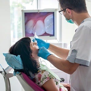 Dentist and patient looking at intraoral images