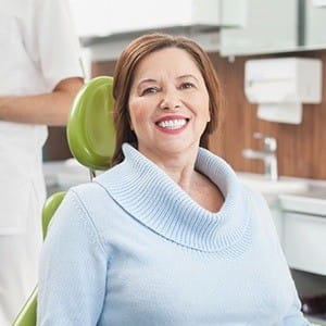 Smiling older woman in dental chair