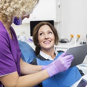 Dentist showing patient dental x-ray