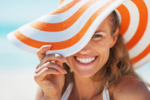 woman with summer hat smiling