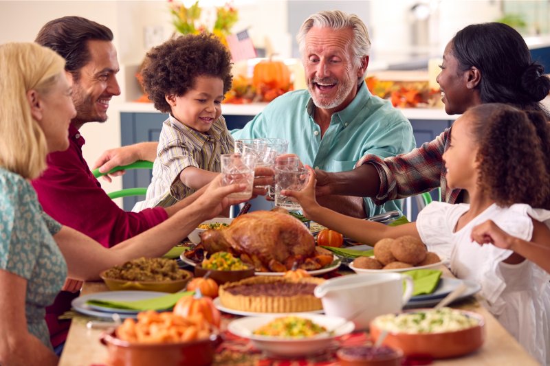 older man eating holiday dinner with family 