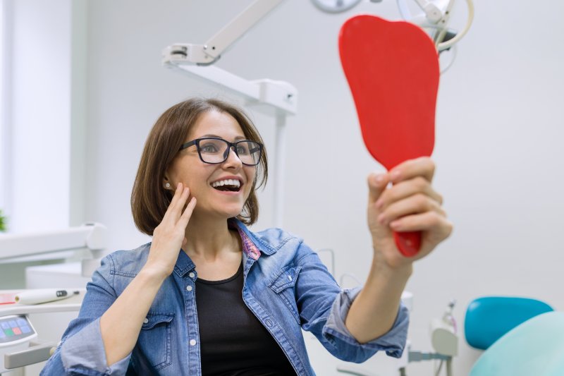 woman smiling after receiving a dental crown 