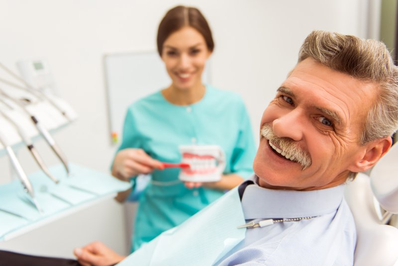 older man smiling at the dentist’s office