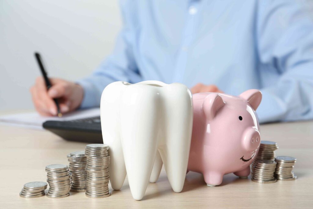 Piggy bank, tooth, and coins